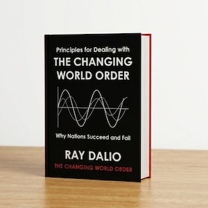 May include: A hardcover book titled Principles for Dealing with THE CHANGING WORLD ORDER by Ray Dalio. The black cover features white text, a white line graph showing wave patterns, and the title repeated in red at the bottom of the front cover.