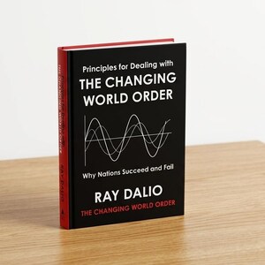 May include: A hardcover book titled Principles for Dealing with The Changing World Order by Ray Dalio. The black cover features white text and a white line graph showing three intersecting waves. The book spine is red with white text.