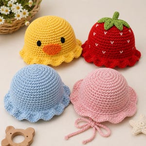 May include: Four handmade crochet hats in a variety of colors. A yellow duck hat, a red strawberry hat, a light blue hat, and a pink hat with a bow. The hats have a scalloped brim.
