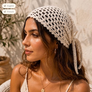 May include: An off-white crochet headscarf featuring an openwork diamond pattern with a scalloped edge. The headscarf is tied at the back with two long, matching crochet fabric ties that hang down, creating a textured and lightweight appearance.