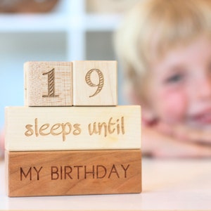 May include: Wooden blocks stacked to spell "19 sleeps until my birthday".