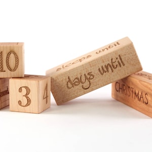 May include: Wooden blocks with numbers 10, 3, 4 and a heart, and a block that says "sleeps until days until Christmas".