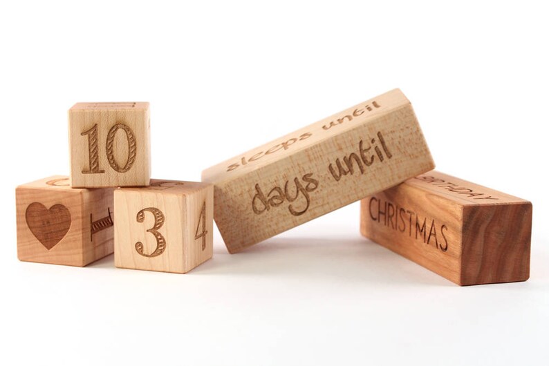 May include: Wooden blocks with numbers 10, 3, 4 and a heart, and a block that says "sleeps until days until Christmas".
