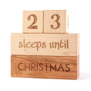 May include: Wooden block countdown calendar with the numbers 23 and the text "sleeps until Christmas".