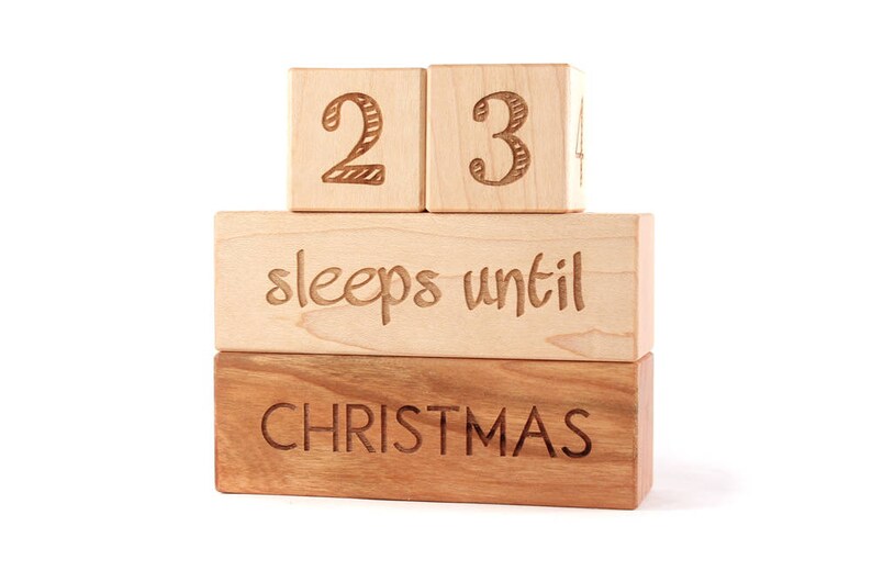 May include: Wooden block countdown calendar with the numbers 23 and the text "sleeps until Christmas".