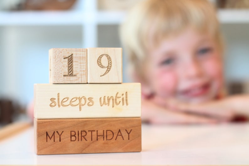 May include: Wooden blocks stacked to spell "19 sleeps until my birthday".