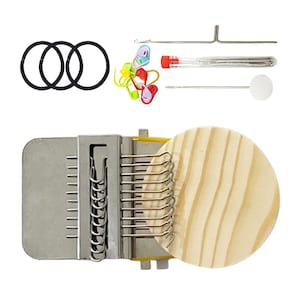 May include: A darning loom kit featuring a metal weaving tool with a round wooden disc, three black elastic bands, a set of colorful plastic stitch markers, a metal needle, a clear tube containing needles, and a metal tool with a white ball end.