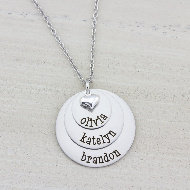 3 layer stainless steel disc necklace with kids name on each layer with a sterling silver heart charm on top.