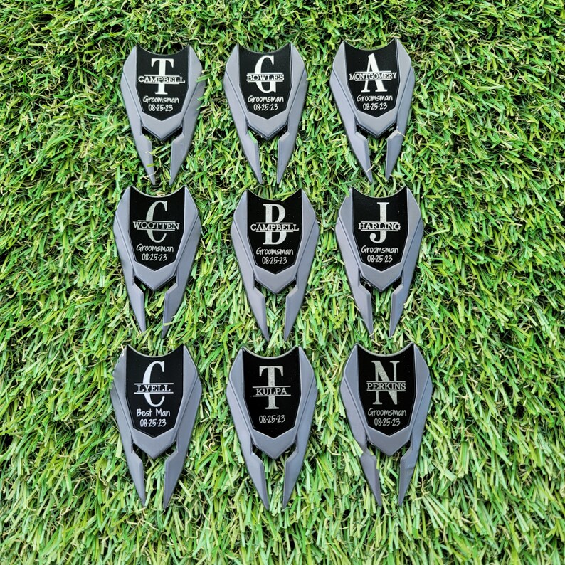 Shows divot tools engraved with a large letter and name through it with title and date under it.