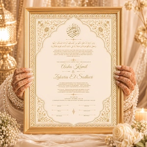 May include: A rectangular gold-framed marriage certificate featuring intricate gold floral borders, Arabic calligraphy, and English text detailing the union of Aisha Kamil and Zakaria El Sadhuri, dated April 24th, 2025, with signature lines for witnesses.