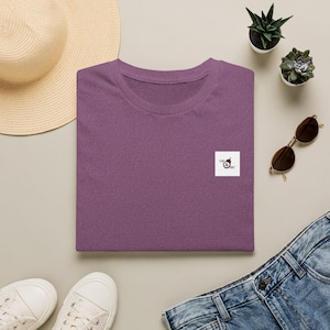 May include: A heathered purple t-shirt featuring a small white square patch on the chest with the black text LOC & SEC and a small graphic icon of a padlock. The shirt has a crew neckline and short sleeves, presented in a folded, flat layout.