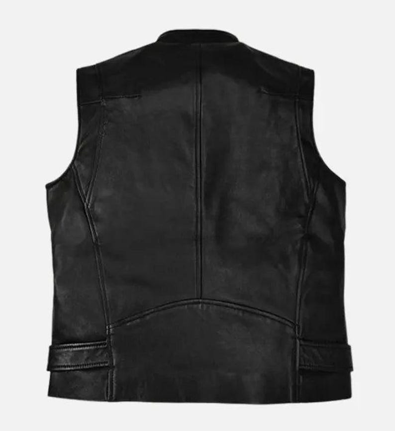 May include: A black leather vest with a stand-up collar. The vest has a tailored fit, with seams and panels creating a structured look. Features include shoulder panels and two small pockets near the waist. The back view shows a curved hemline.