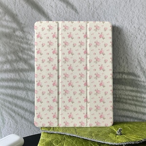 May include: A handmade wooden sign displaying the word "Welcome" in a whimsical font. The sign has a distressed white backdrop and a dark stained wooden frame. A decorative floral element is in the corner.