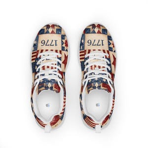 May include: Pair of trainers with a patriotic design. The shoes feature a patchwork pattern in red, white, and blue, with the number "1776" displayed on the top. The shoes have white laces and soles.