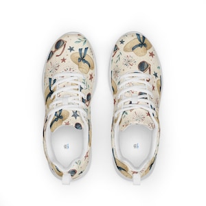 May include: Pair of white sneakers with a repeating pattern of straw hats with blue ribbons, sunglasses, red stars, and fireworks on a cream background. The shoes have white laces and soles.