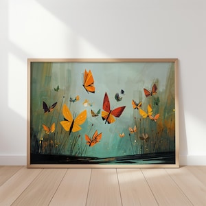 Puede incluir: Una impresión artística enmarcada que presenta una vibrante ilustración de mariposas en vuelo. La obra de arte muestra mariposas en tonos naranja, amarillo y rojo sobre un fondo verde azulado. La impresión se muestra en un marco de madera.