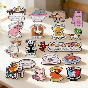 May include: A selection of vibrant, cartoon stickers with diverse designs and text. The stickers depict animals, food items, and funny sayings. Some stickers include a dog with the text "ALWAYS WASH YOUR WIENER" and a sloth with the text "I LIKE NAPS".