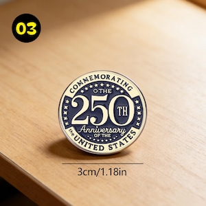 May include: A round commemorative pin, 1.18 inches in diameter, celebrating the 250th anniversary of the United States. The pin features the text "Commemorating the 250th Anniversary of the United States" in a circular design with a navy blue and gold color scheme.
