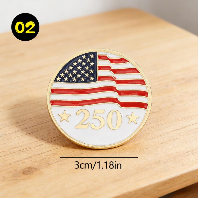 May include: A round, gold-colored pin with a design of the American flag. The pin features red and white stripes, blue stars, and the number "250" in gold. The pin measures 1.18 inches in diameter.