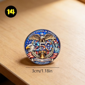 May include: A round commemorative coin with a patriotic design. The coin features an eagle, the Statue of Liberty, and the text "250" with the dates 1776-2026. The coin is 1.18 inches in diameter.
