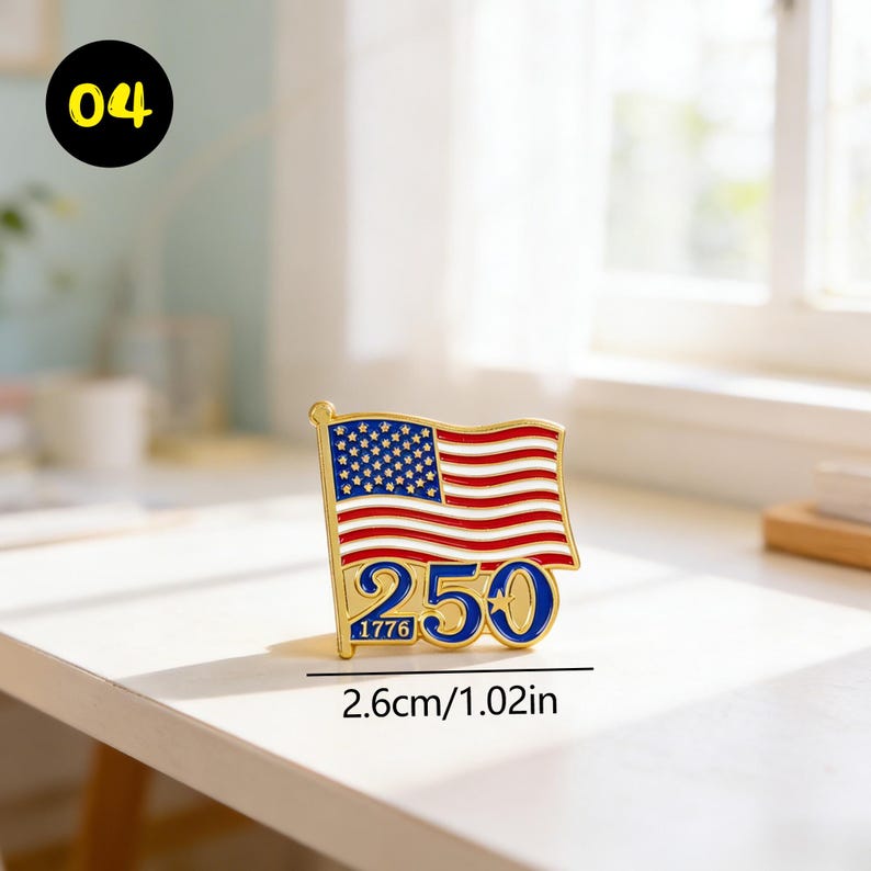 May include: A gold-colored pin featuring the American flag with red and white stripes and blue stars. The pin includes the number "250" in blue and the year "1776". The pin measures 1.02 inches in width.