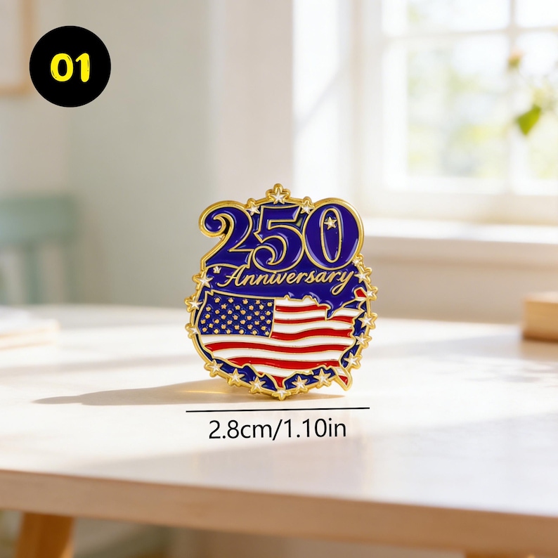 May include: A gold-colored pin with a blue and red design. The pin features the text "250 Anniversary" and an American flag design. The pin is 1.10 inches in diameter.
