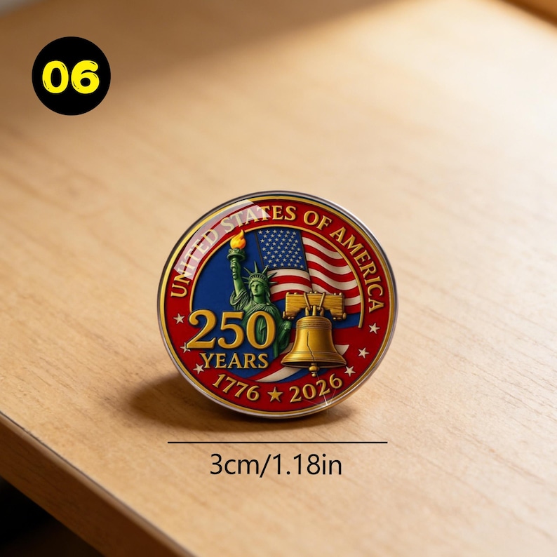 May include: A round commemorative coin with a diameter of 1.18 inches. The coin features the Statue of Liberty, a waving American flag, and the Liberty Bell. The text reads "UNITED STATES OF AMERICA" and "250 YEARS 1776-2026".