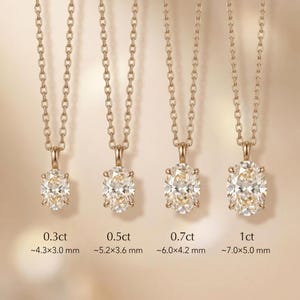 May include: Four gold necklaces, each with an oval-cut diamond pendant. Sizes range from 0.3ct to 1ct. The pendants are suspended from fine gold chains. Dimensions are provided in millimeters: 0.3ct (~4.3x3.0mm) to 1ct (~7.0x5.0mm).