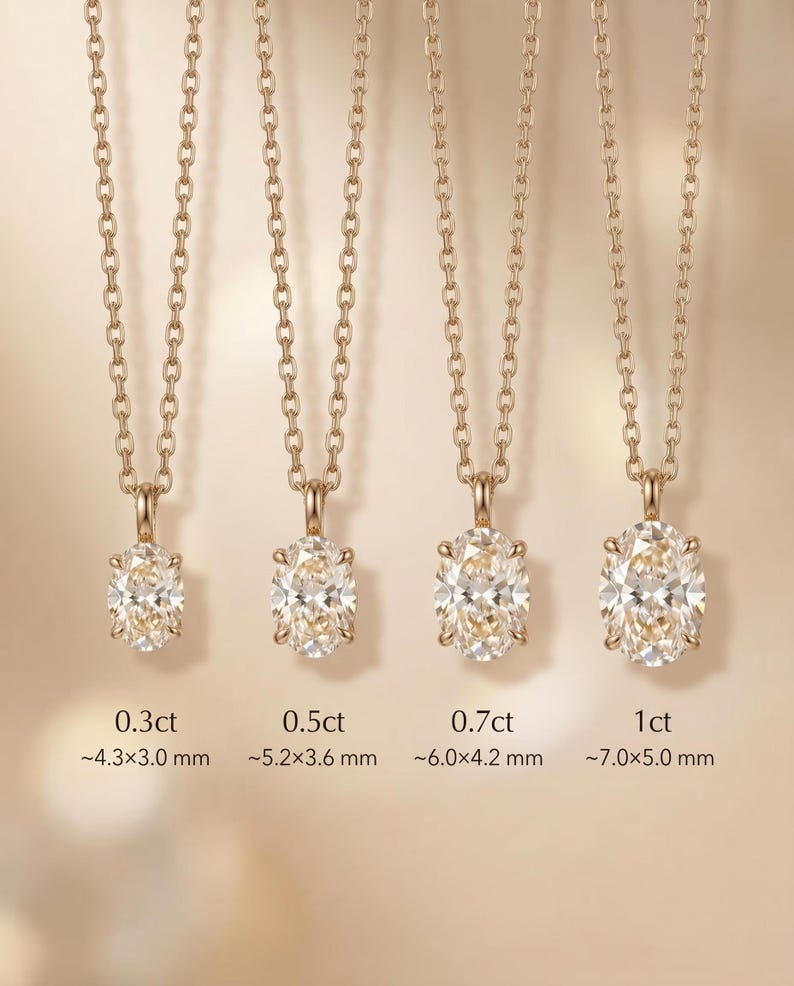 May include: Four gold necklaces, each with an oval-cut diamond pendant. Sizes range from 0.3ct to 1ct. The pendants are suspended from fine gold chains. Dimensions are provided in millimeters: 0.3ct (~4.3x3.0mm) to 1ct (~7.0x5.0mm).