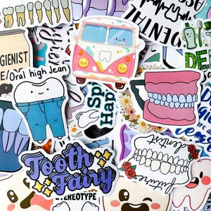 May include: A white ceramic mug with a black handle and the text "But First, Coffee" in a bold, black font. The mug is set against a blurred background, suggesting a cosy setting.