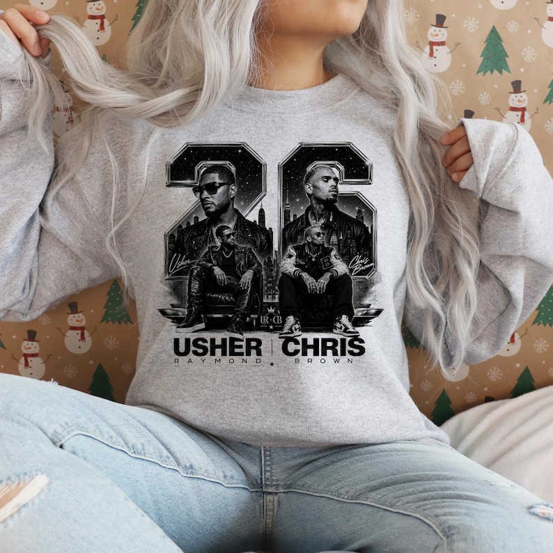 A black and white digital art piece featuring portraits of singers Usher and Chris Brown sitting in front of a stylized city skyline with the text "USHER x CHRIS" and decorative "22" branding elements.