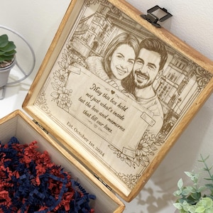 Puede incluir: Una caja de recuerdos de madera con tapa abatible que presenta un retrato grabado con láser de una pareja, detalles florales y el texto: May this box hold not just what's inside but the love and memories that fill our lives. Est. October 1st, 2024.