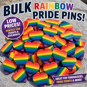 May include: A pile of heart-shaped pins with rainbow stripes. The pins are in various orientations, with the text "BULK RAINBOW PRIDE PINS!" at the top. Additional text includes "LOW PRICES!" and "GREAT FOR FUNDRAISERS, PRIDE EVENTS & MORE!"