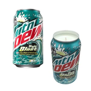 May include: Two teal-colored Mountain Dew Baja Blast cans, one intact and the other repurposed as a candle. The cans feature the Mountain Dew logo and Baja Blast text with a wave design. The candle has a white wax top.