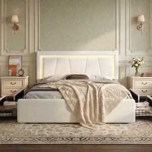 May include: A white upholstered bed frame with a geometric paneled headboard featuring integrated warm LED lighting. The bed includes two pull-out storage drawers at the base, each containing folded textiles, and is dressed in neutral bedding.