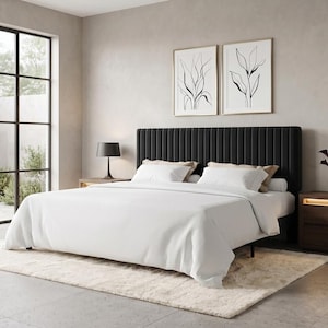 May include: A bedroom set featuring a black vertical channel-tufted headboard, a white bedspread, two dark wood nightstands with integrated warm lighting, a black table lamp, and two framed black and white botanical line art prints on the wall.