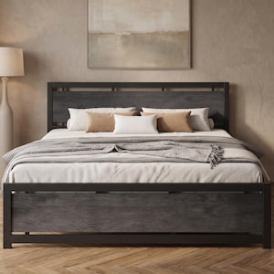 May include: A bed frame featuring a dark charcoal gray wood grain headboard and footboard with a black metal frame. The bed is dressed with white sheets, a gray textured throw blanket, and three rectangular pillows in tan and white colors.