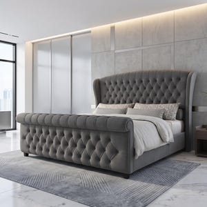 May include: A grey upholstered bed frame featuring a high, tufted wingback headboard and a matching tufted scroll footboard. The bed is dressed with white bedding and two patterned rectangular pillows, showcasing a button-tufted design.