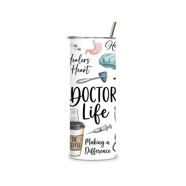 May include: A white tumbler with a stainless steel straw, decorated with medical illustrations. The design includes a stomach, pills, a surgical cap, a reflex hammer, and the words "Doctor Life" and "Healers Heart". A coffee cup reads "Dr. Coffee".