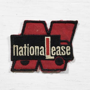 May include: A red and black embroidered patch with the text "National Lease" in white lettering. The patch features a stylized "N" with a truck inside.