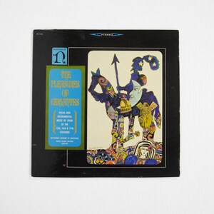 May include: Vintage vinyl record album cover for "The Pleasures of Cervantes." The cover features a colorful illustration of a knight on horseback with text in a blue and green box. The album is labeled "Stereo."