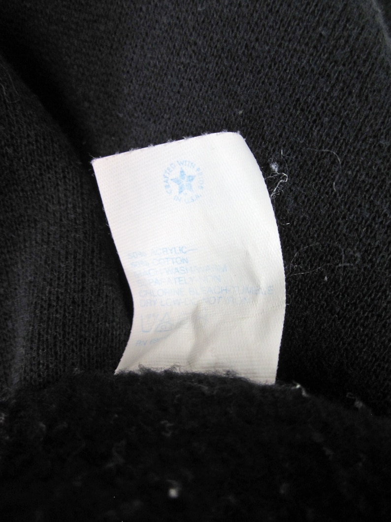 May include: White care label with blue text and a blue star logo that says "crafted with pride" and "baskin". The label has instructions for washing and drying the garment.