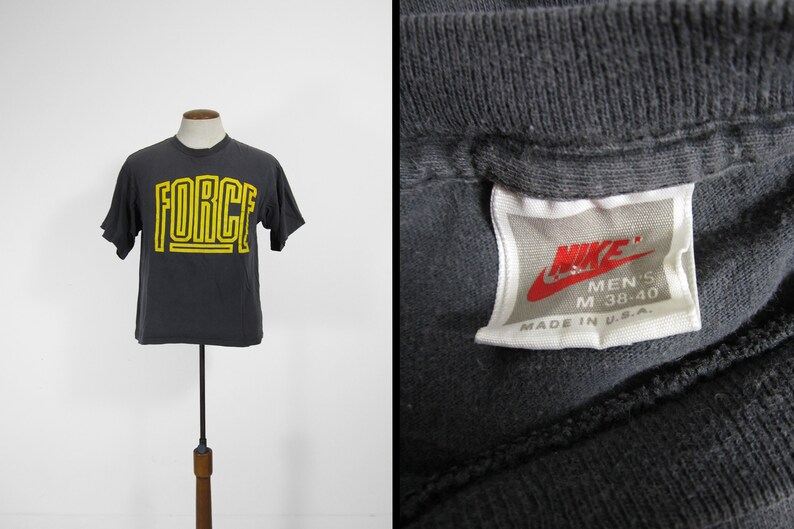 grey and yellow nike shirt