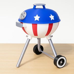 May include: A small barbecue grill featuring a blue lid with white stars. The body is white with red stripes, supported by silver legs and black wheels. The design is reminiscent of the American flag, suitable for outdoor cooking.