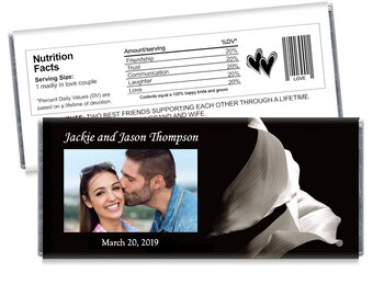 May include: A black and white wedding favor chocolate bar with a photo of a couple and the text "Jackie and Jason Thompson" and "March 20, 2019". The bar also features a black and white image of calla lilies and the text "Two best friends supporting each other through a lifetime."