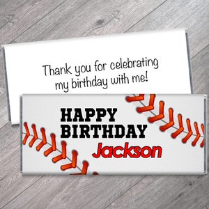 May include: White chocolate bar wrapper with a baseball graphic. The wrapper has red stitching and the text "Happy Birthday Jackson".