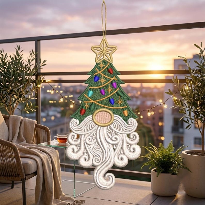 May include: A hanging Christmas tree ornament featuring an embroidered green tree with a gold star topper, colorful light bulb accents, and a gnome face with a large, swirling white beard and a round, light pink nose, suspended by a gold cord.