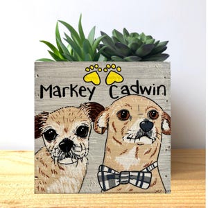 a wooden box with a picture of two dogs on it