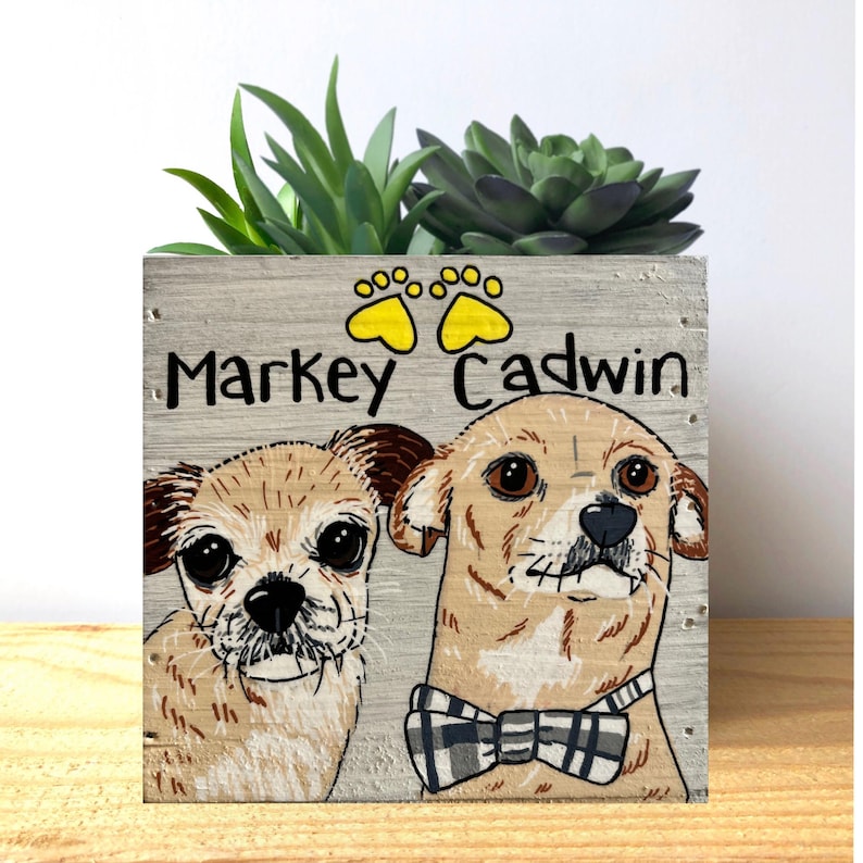 a wooden box with a picture of two dogs on it