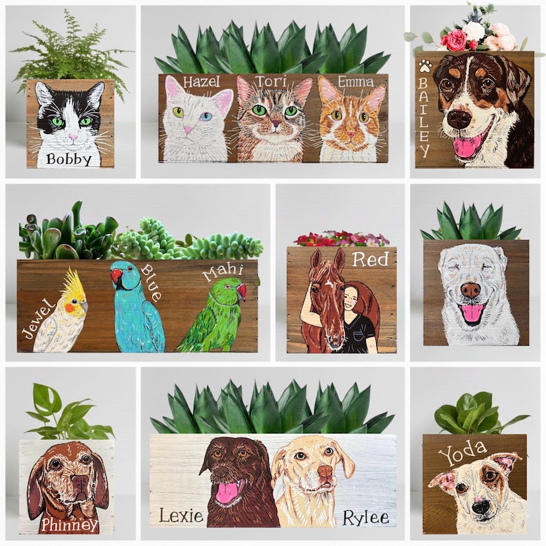 May include: Wooden planters with painted portraits of pets, including cats, dogs, and a horse. Each planter features a different pet's name, such as "Bobby," "Bailey," and "Red." The planters are filled with greenery.